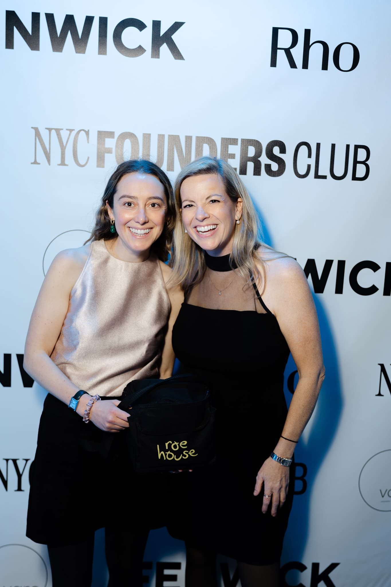 Two women at backdrop
